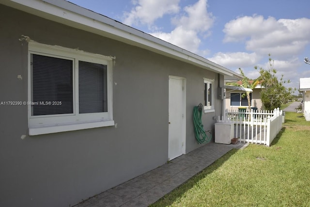 4701 NW 43rd Ave, Tamarac, FL 33319 - exterior space featuring fence, stucco siding, and a lawn