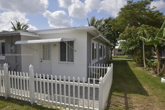 4701 NW 43rd Ave, Tamarac, FL 33319 - view of side of home with fence, stucco siding, and a yard