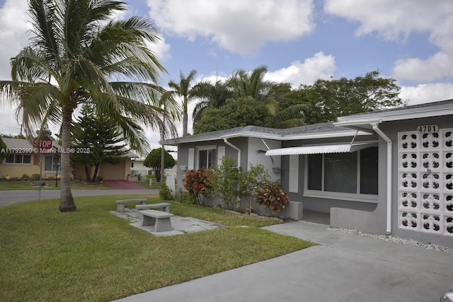 4701 NW 43rd Ave, Tamarac, FL 33319 - exterior space with a lawn and stucco siding