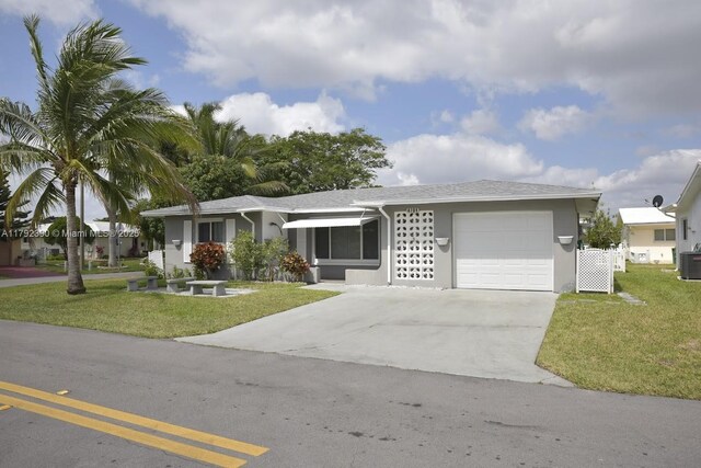 4701 NW 43rd Ave, Tamarac, FL 33319 - single story home with a garage, stucco siding, driveway, and a front yard