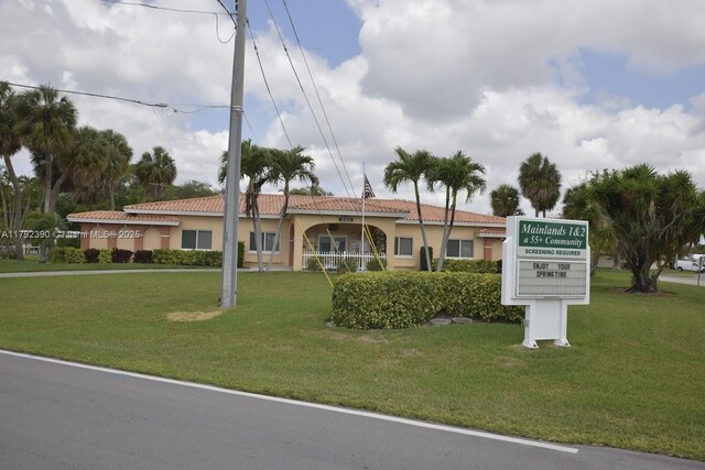 4701 NW 43rd Ave, Tamarac, FL 33319 - view of front of property featuring a tiled roof, stucco siding, and a front yard