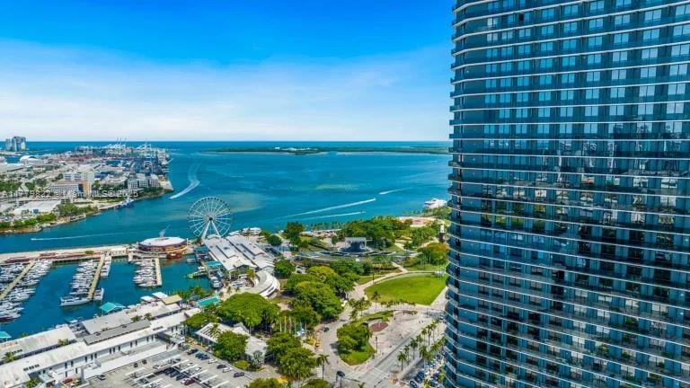 birds eye view of property with a water view and a city view