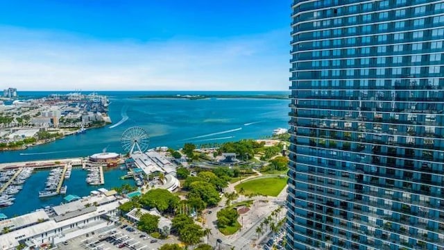 birds eye view of property with a water view and a city view