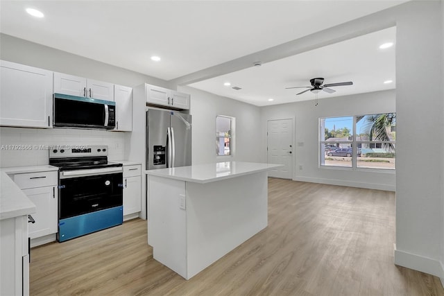 kitchen with decorative backsplash, ceiling fan, light wood-type flooring, light countertops, and stainless steel appliances