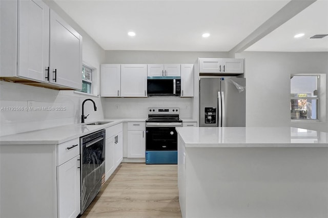 kitchen featuring visible vents, light countertops, a sink, backsplash, and stainless steel appliances
