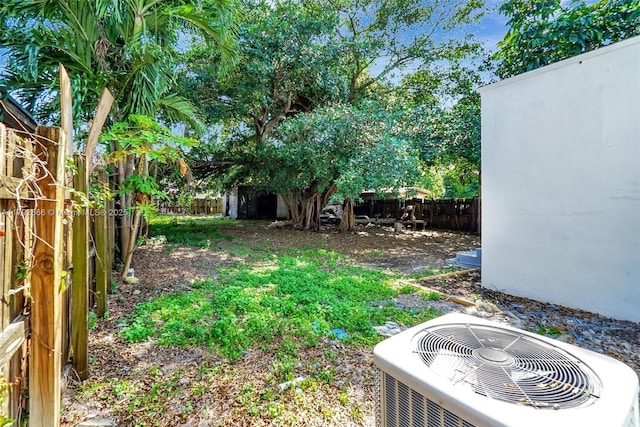 view of yard featuring a fenced backyard and central AC