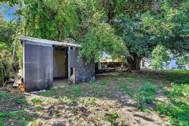 view of yard with a shed and an outbuilding
