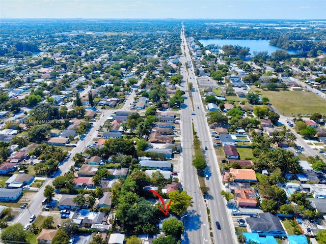 birds eye view of property with a water view and a residential view