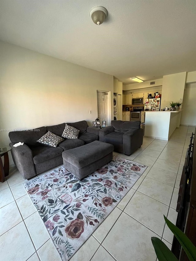 living area featuring a textured ceiling and light tile patterned floors