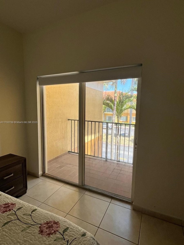 unfurnished bedroom featuring access to outside and light tile patterned floors