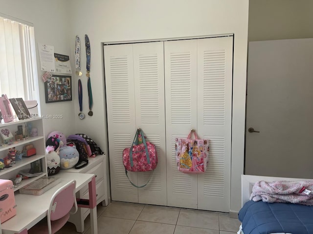 bedroom featuring a closet and light tile patterned floors