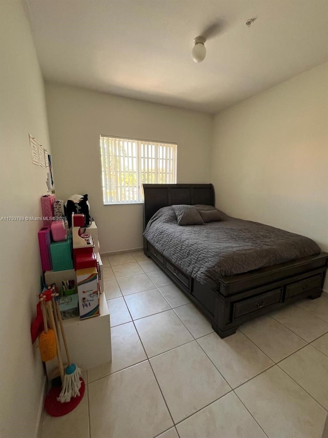 bedroom featuring baseboards and light tile patterned floors