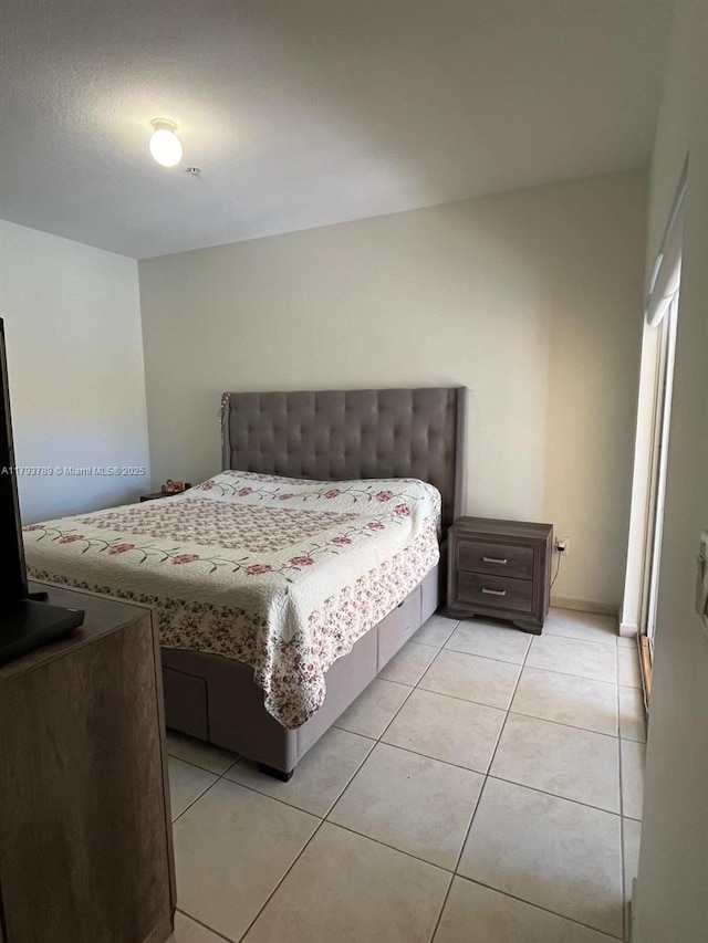 bedroom featuring light tile patterned floors