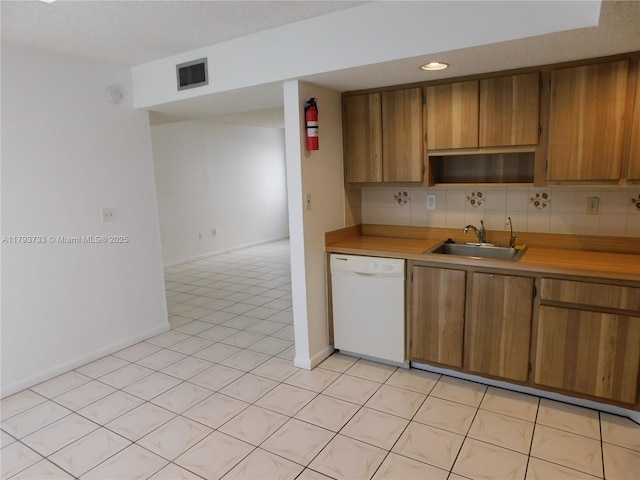 8005 SW 107th Ave Unit 118, Miami, FL 33173 - kitchen featuring brown cabinets, a sink, dishwasher, light countertops, and visible vents