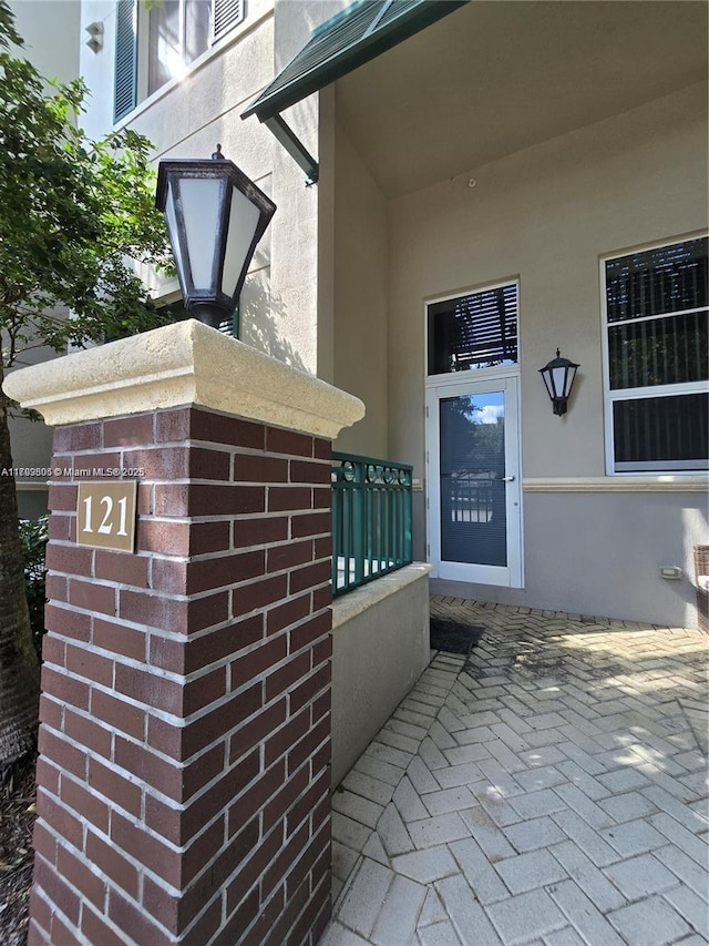 entrance to property featuring stucco siding