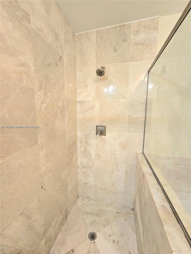 full bath featuring a tile shower