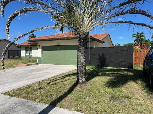 view of home's exterior featuring a lawn, fence, concrete driveway, an attached garage, and stucco siding