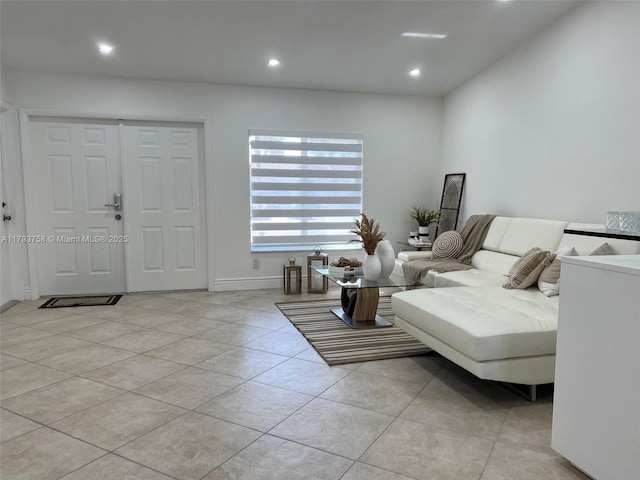 tiled living room with recessed lighting and baseboards