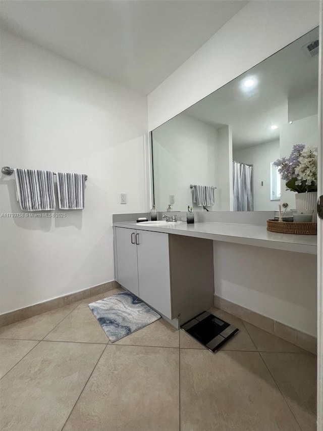 bathroom featuring baseboards, tile patterned floors, visible vents, and vanity