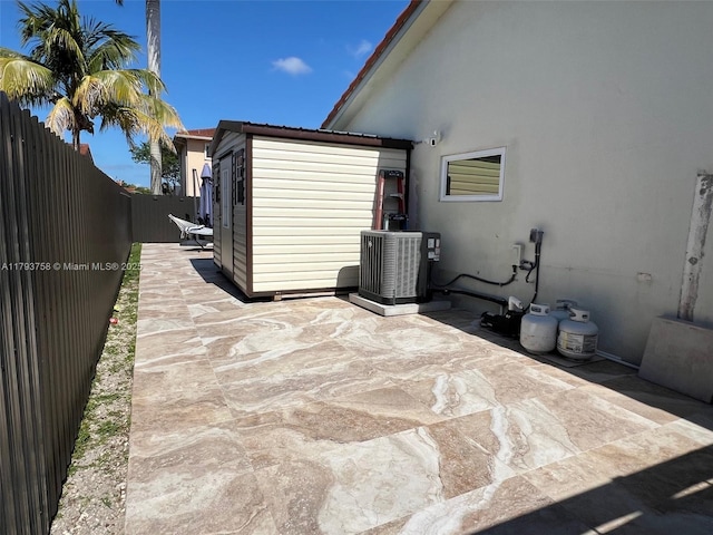 view of patio with central AC and a fenced backyard