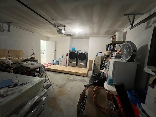 garage with a garage door opener and independent washer and dryer