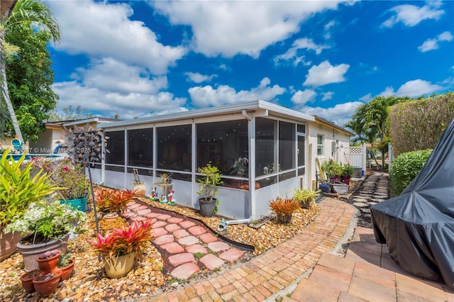 22483 Labrador St, Boca Raton, FL 33428 - rear view of house with a sunroom and a patio