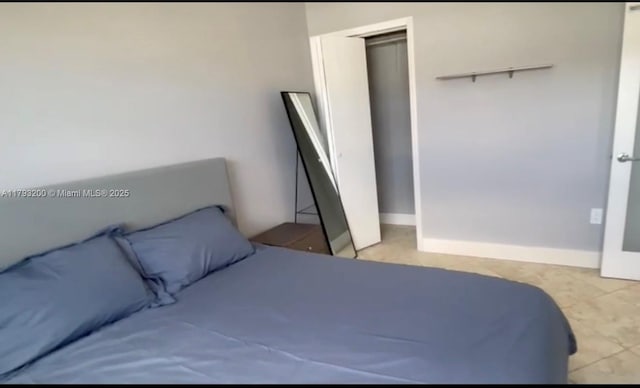 1881 Washington Ave Unit 8C, Miami Beach, FL 33139 - bedroom featuring a closet and light tile patterned floors