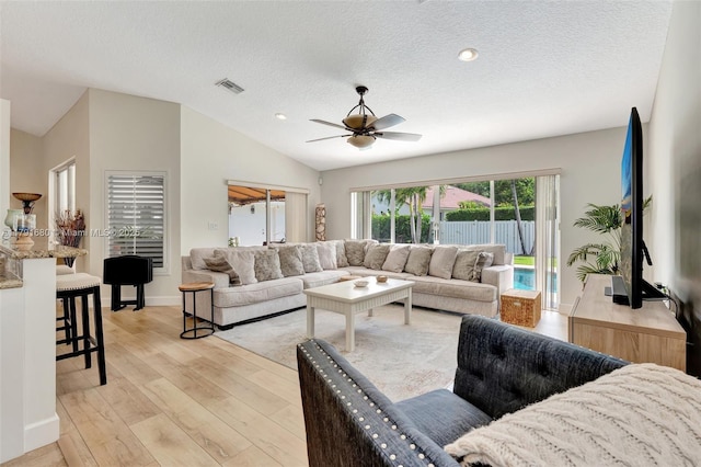 5133 N Springs Way, Coral Springs, FL 33076 - living area with light wood finished floors, visible vents, a textured ceiling, a ceiling fan, and vaulted ceiling