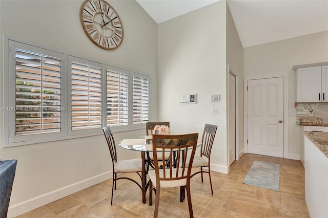 5133 N Springs Way, Coral Springs, FL 33076 - dining area with baseboards and a towering ceiling