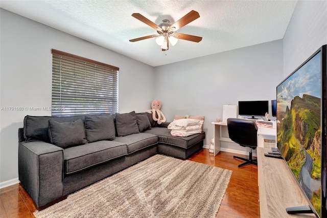 5133 N Springs Way, Coral Springs, FL 33076 - living area featuring a textured ceiling, baseboards, a ceiling fan, and wood finished floors