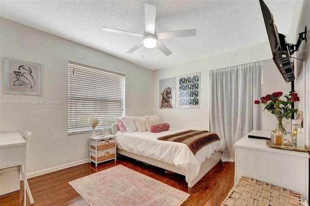 5133 N Springs Way, Coral Springs, FL 33076 - bedroom featuring baseboards, a ceiling fan, a textured ceiling, and wood finished floors
