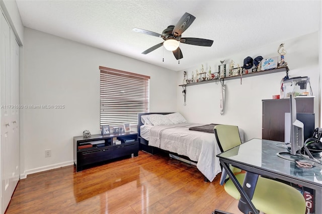 5133 N Springs Way, Coral Springs, FL 33076 - bedroom with a textured ceiling, ceiling fan, wood finished floors, and a closet