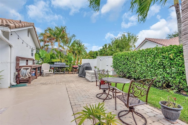 5133 N Springs Way, Coral Springs, FL 33076 - view of patio featuring a fenced backyard, outdoor dining area, and a grill