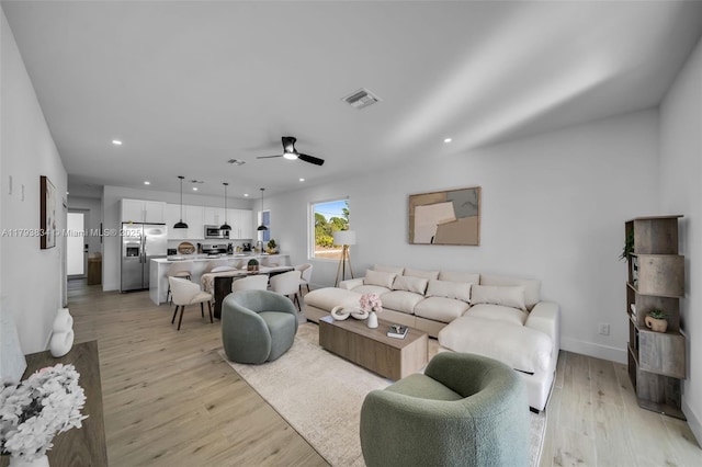 932 Alcalde St E, Lehigh Acres, FL 33974 - living room with light wood-style floors, ceiling fan, recessed lighting, and visible vents