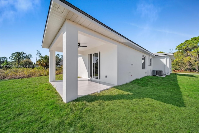 932 Alcalde St E, Lehigh Acres, FL 33974 - back of property featuring a patio, a ceiling fan, a lawn, and stucco siding