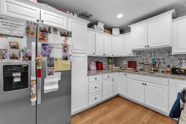 3500 SW 87th Pl, Miami, FL 33165 - kitchen featuring light wood-style flooring, a sink, stainless steel refrigerator with ice dispenser, white cabinets, and backsplash