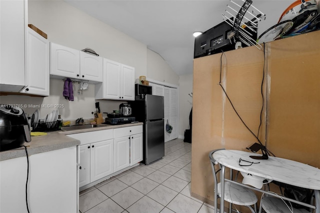3500 SW 87th Pl, Miami, FL 33165 - kitchen with white cabinetry, light countertops, freestanding refrigerator, and light tile patterned floors