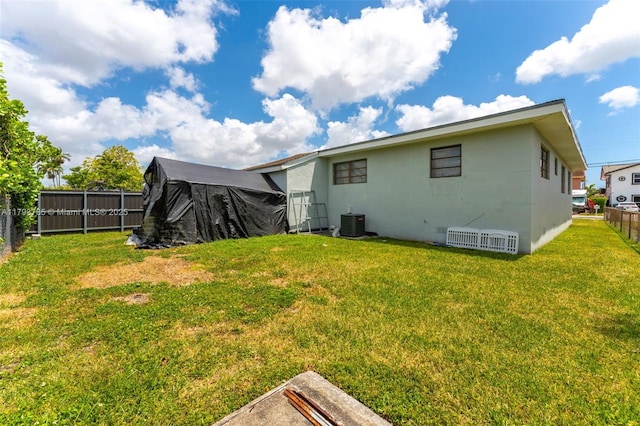3500 SW 87th Pl, Miami, FL 33165 - back of house featuring a lawn, central AC unit, and a fenced backyard