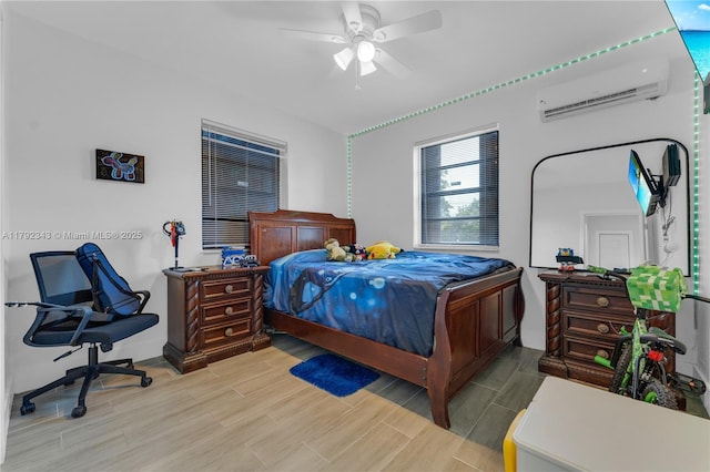 bedroom with an AC wall unit, a ceiling fan, and wood finish floors