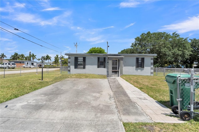 view of front of property with fence, stucco siding, and a front lawn