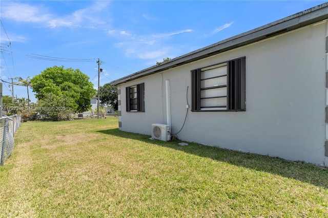 view of yard with fence and ac unit