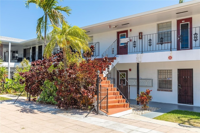 view of front of property featuring stucco siding and stairway