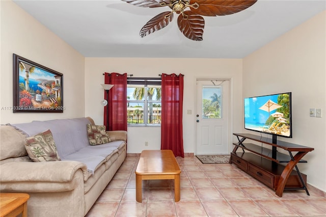 living area featuring light tile patterned floors and ceiling fan