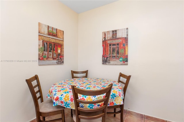 dining space with tile patterned floors and baseboards
