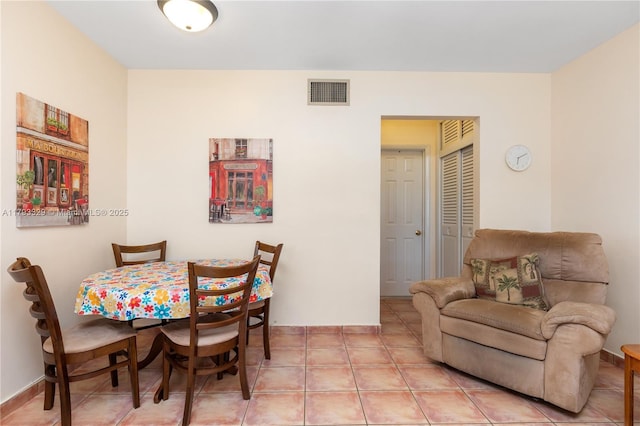 dining area featuring light tile patterned floors and visible vents