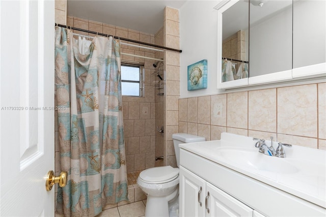 full bath featuring tile walls, tile patterned flooring, vanity, toilet, and tiled shower
