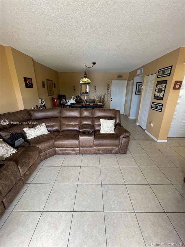 8240 SW 210th St Unit 214, Cutler Bay, FL 33189 - living room featuring light tile patterned flooring, a textured ceiling, and visible vents