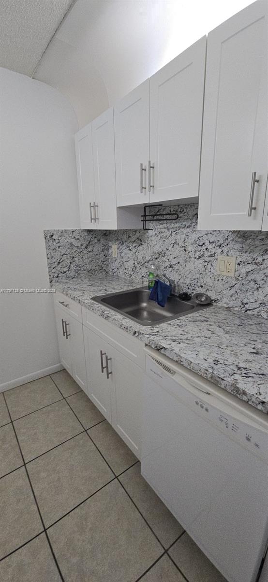 8240 SW 210th St Unit 214, Cutler Bay, FL 33189 - kitchen featuring dishwasher, light tile patterned floors, white cabinets, and a sink