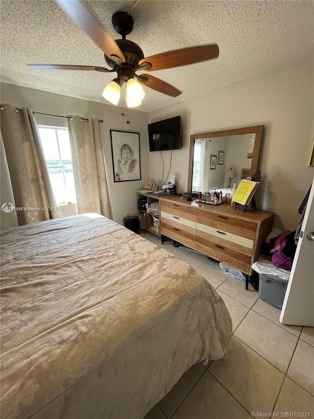 8240 SW 210th St Unit 214, Cutler Bay, FL 33189 - bedroom featuring multiple windows, light tile patterned flooring, and a textured ceiling