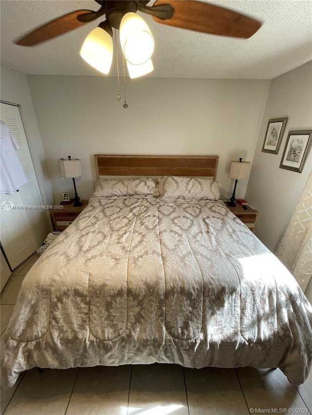 8240 SW 210th St Unit 214, Cutler Bay, FL 33189 - tiled bedroom featuring a textured ceiling and ceiling fan